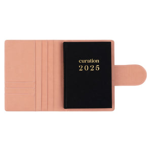 Compendium flamingo pink color with Curation 2025 Planner inside