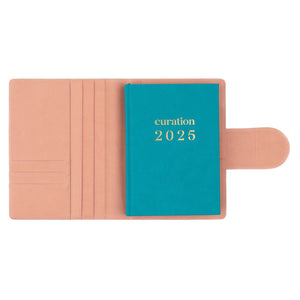 Compendium flamingo pink color with Curation 2025 Planner inside