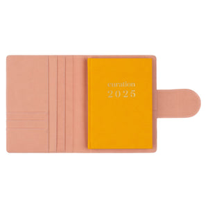 Compendium flamingo pink color with Curation 2025 Planner inside