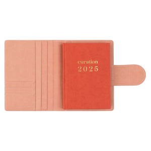 Compendium flamingo pink color with Curation 2025 Planner inside