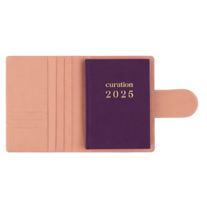 Compendium flamingo pink color with Curation 2025 Planner inside